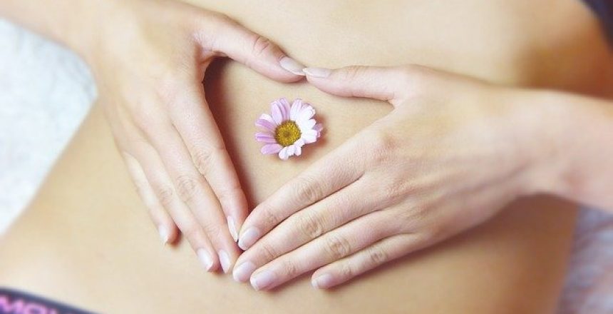 health and wellness business name featured image- fit women with flower heart on stomach